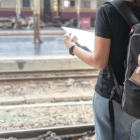 Street thief stealing a wallet from woman tourist backpack